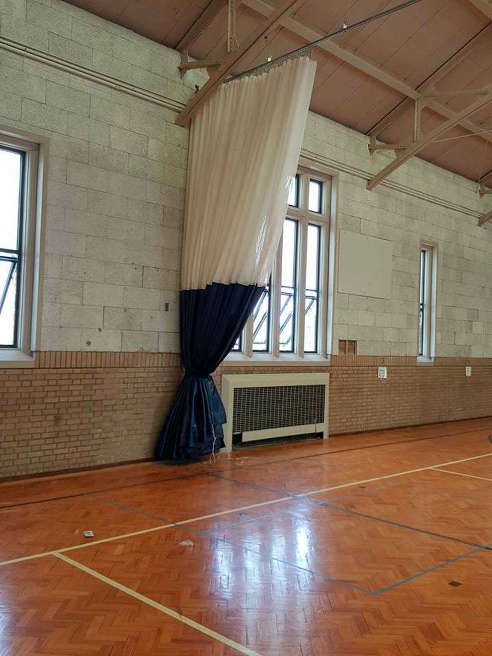 large curtain on track for basketball court