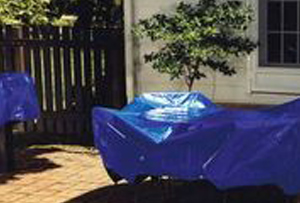 Blue sunshield covering patio furniture
