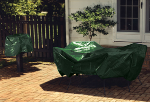 Green sunshield tarp covering patio furniture