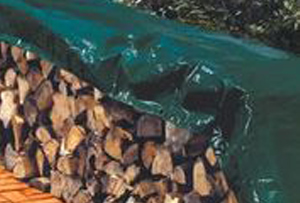 Landscaping tarp covering wood pile
