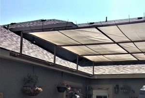 Shade tarp attached to roof for patio shade