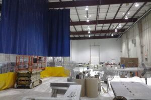 Industrial divider curtain separating spaces in a warehouse