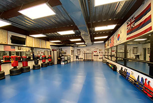 Martial arts facility with blue tarp covering the ground